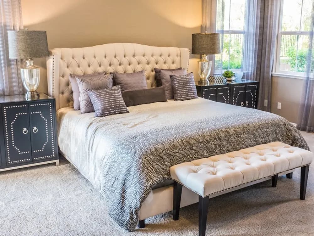 Freshly made bed with crisp linens in a bright bedroom
